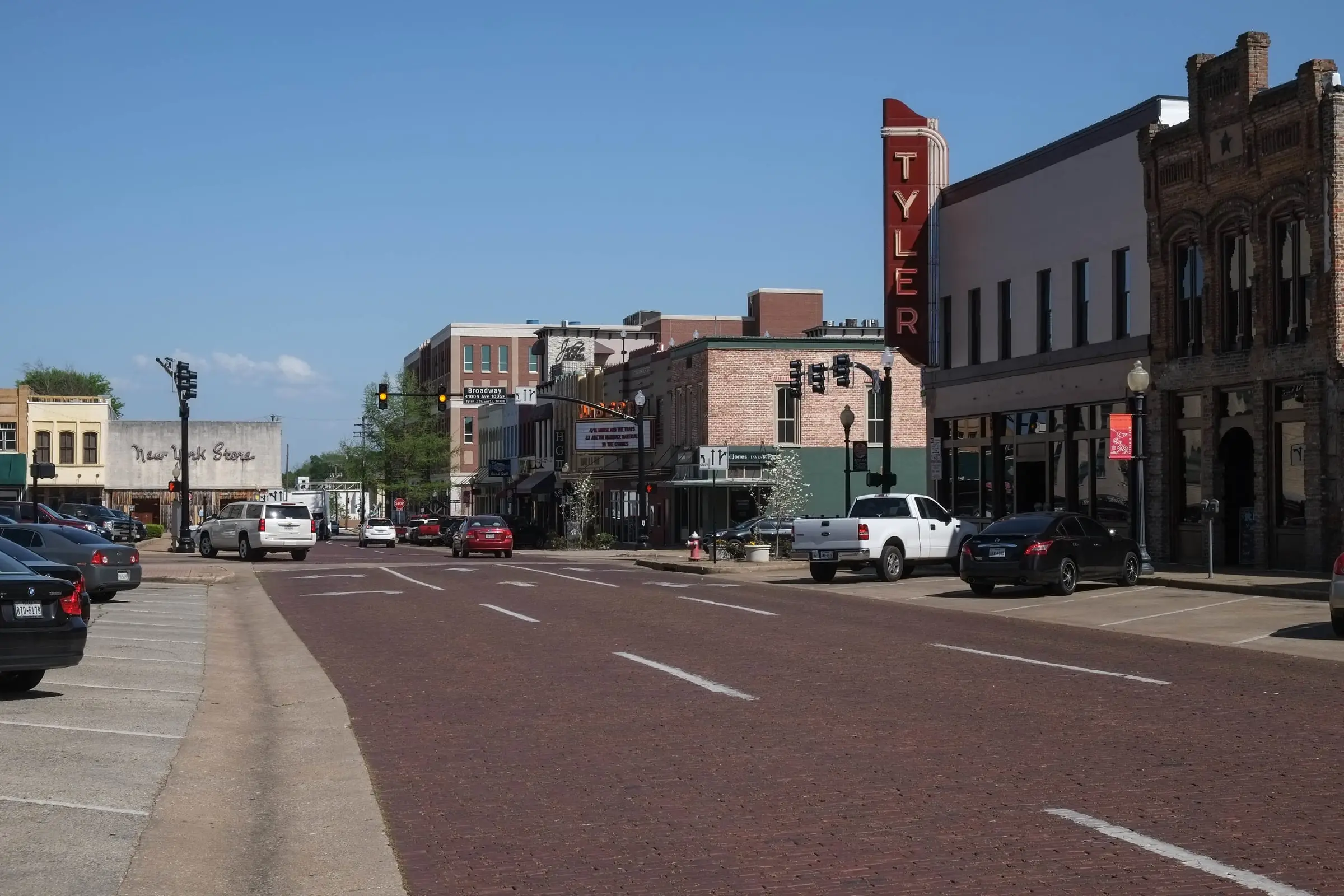 Brick-paved downtown street with the vertical TYLER theater sign